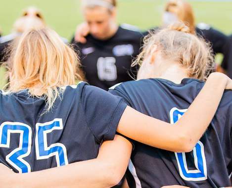 GPS student athletes huddling with their coach