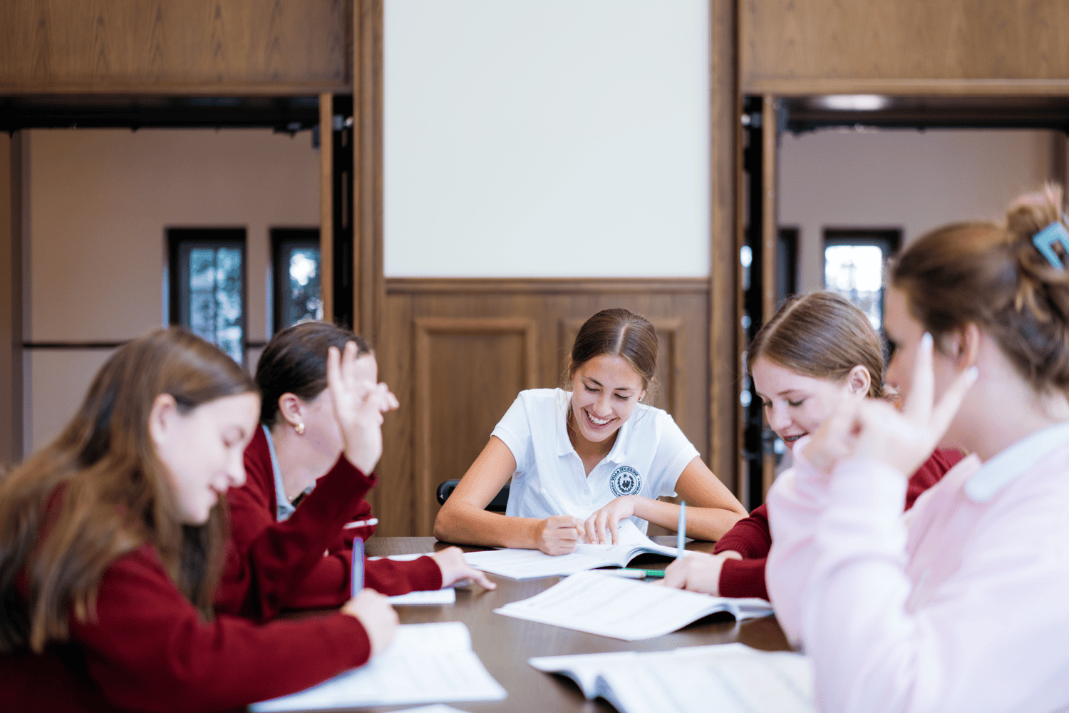 Villa Duchesne students laughing and collaborating in class